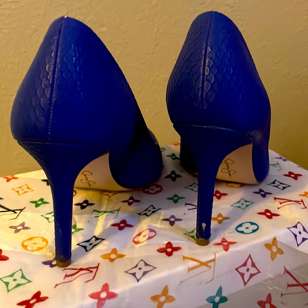 Mild scratch on one heel and gently worn.